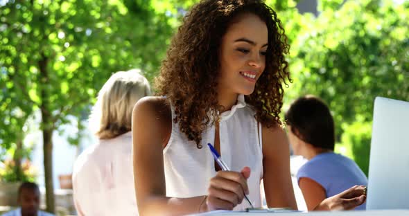 Woman using laptop at restaurant