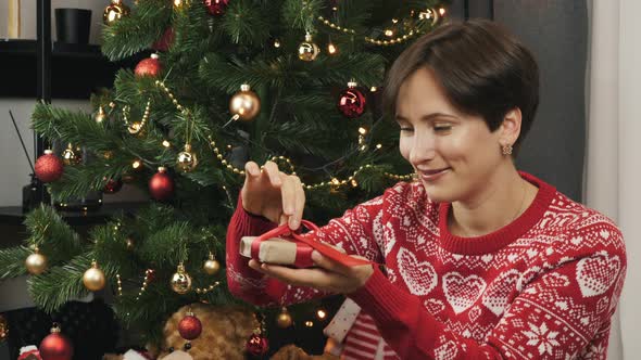 Woman is opening Christmas present