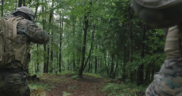 Soldiers Moving Through Forest During Tactical Action Concept of War and Attacking