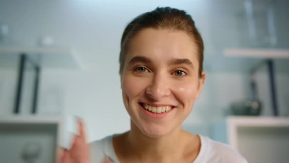 Smiling Girl Recording Blog at Home Closeup