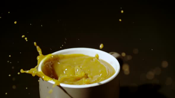 Sugar cubes falling into coffee cup, Ultra Slow Motion