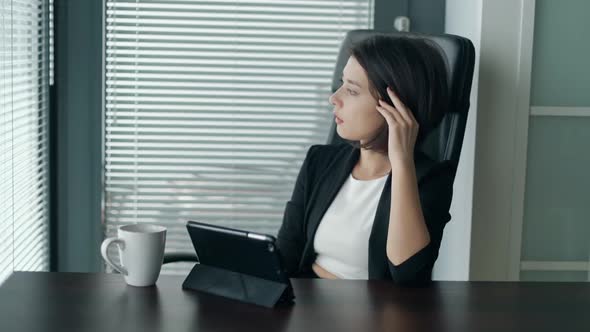 Young Business Lady Sitting Behind the Desk with Tablet, Shaking Head, Being Dissapointed and Tired