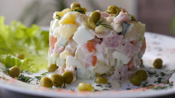 Russian Salad Olivier on a White Plate