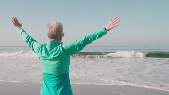 Senior Woman Exercising At The  Beach