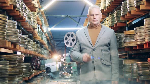 Male Employee in the Film Archive with a Vintage Projector