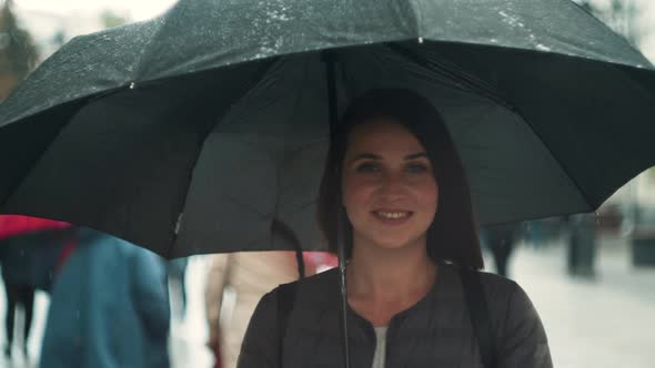 Portrait of Smiling Woman Under Umbrella in Rain. Tourist Girl Under Umbrella in Rain