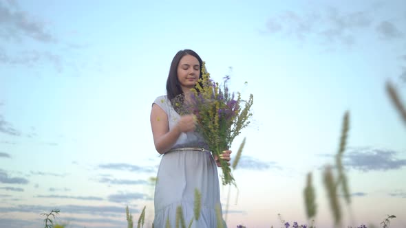 Florist Woman With Bouquet Of Field Flowers