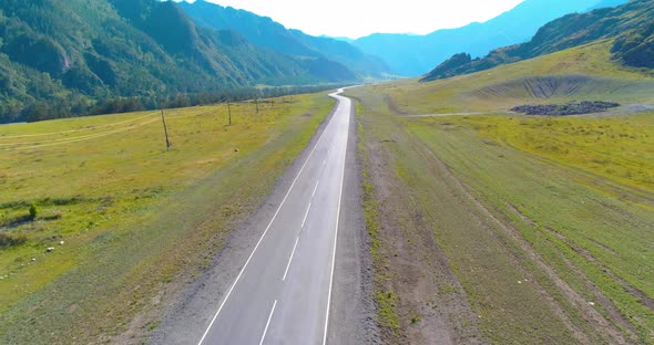 Flight Over Mountain Asphalt Highway Road and Meadow