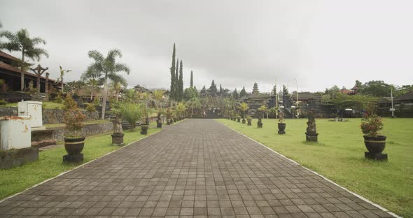 Slow Dolly Shot of Walking on the Cobblestone Road Surrounded By Beautiful Stone Statues on the