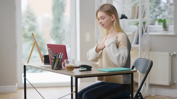 Positive Smiling Young Woman Waving in Video Chat and Gesturing Using Sign Language