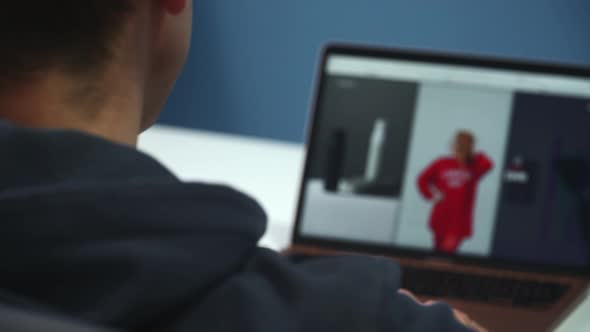 Close Up Of A Young Man Working On A Website On A Laptop