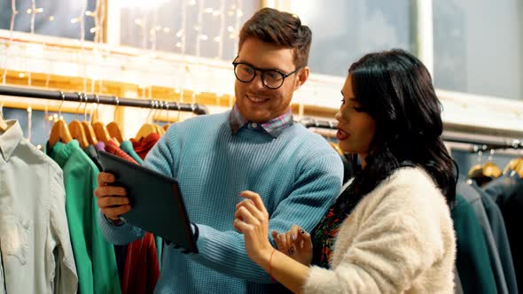 Couple with Tablet Computer at Clothing Store 