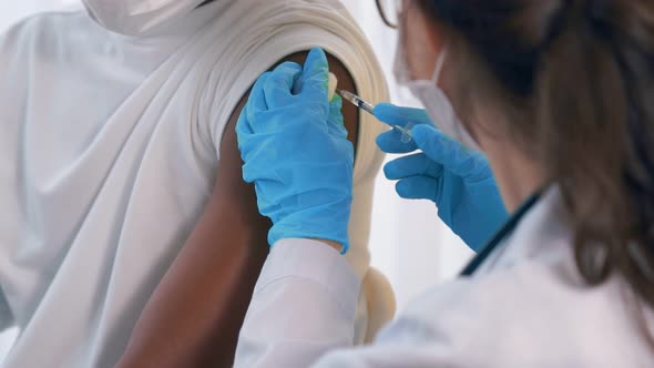 Young Man Visits Skillful Doctor at Hospital for Vaccination