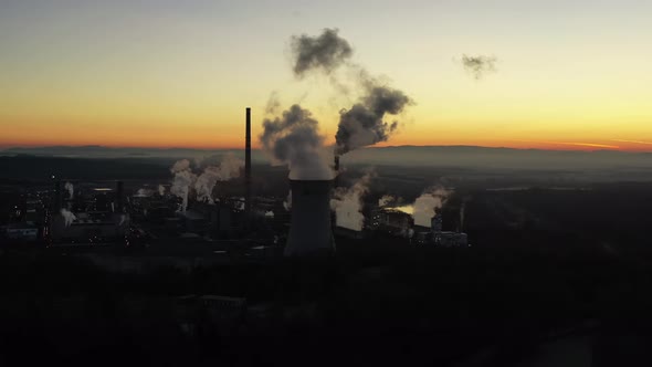 Aerial View of Coal Thermal Power Plant in Twilight. Smoke and Vapor in the Air, Drone Shot