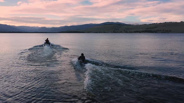 A watercraft pulling person up on the water as they kneeboard