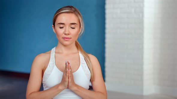 Relaxed Young Woman Closed Eyes Enjoying Meditation Indoor Showing Hand Namaste Gesture at Home