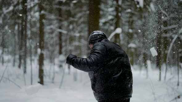 Box Training in Forest in Winter Day Adult Man in Black Clothes is Striking Air By Hands