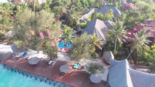 Tropical Landscape of Zanzibar Waves Hit Reef on Hotels Coastline with Palms