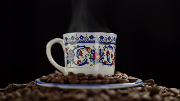 Coffee cup and coffee beans. Hot ceramic coffee cup with smoke