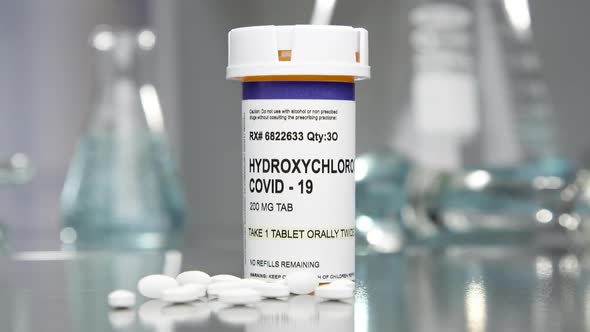 Hydroxychloroquine covid-19 pills and bottle in medical lab 