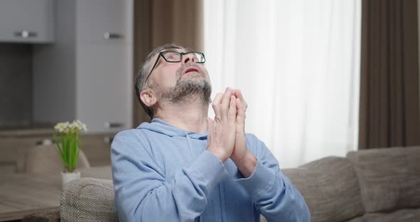 Adult Funny Man with Glasses and Grey Hair Wants Something to Happen Crossing His Fingers