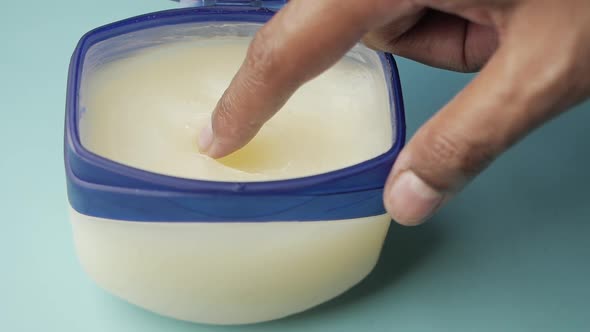 Slow Motion of Man Hand Using Petroleum Jelly