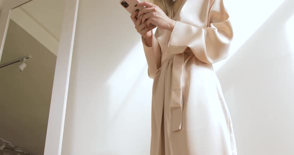 Young And Cute Blonde Looking In The Mirror, And Taking Photos. Low Angle