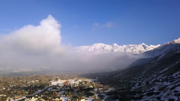 View of houses below the clouds on a blue bird day in Utah