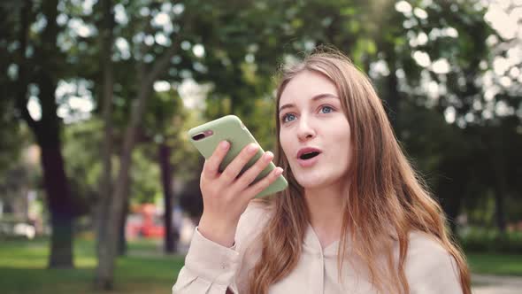 Voice assistant. Student speak with a virtual assistant. Voice recognition. Woman uses smartphone.