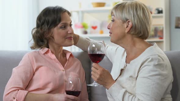 Two Women Drinking Wine, Having Casual Conversation, Sharing Positive News