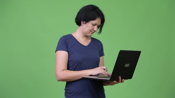 Beautiful Woman with Short Hair Using Laptop