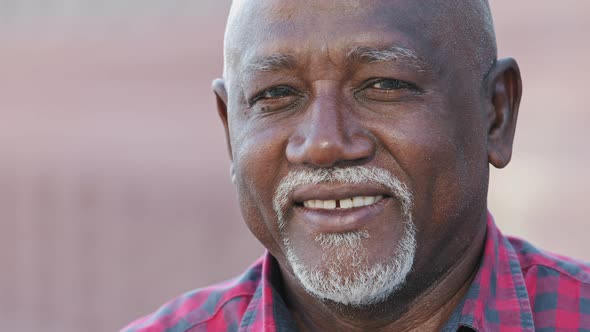 Head Shot Portrait Senior Retired Black Man with Healthy Smile Looking at Camera Close Up Friendly
