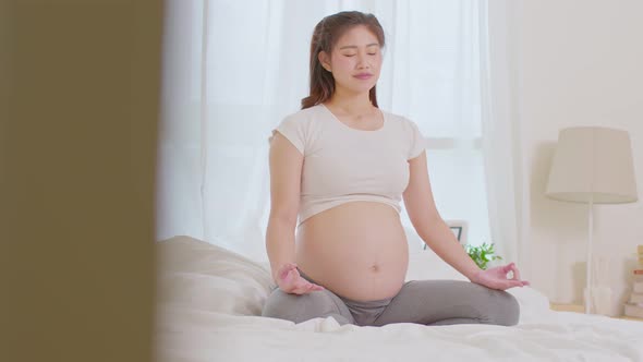 Happy Calm Pregnant Woman deep breath with fresh air do yoga lotus pose comfortable