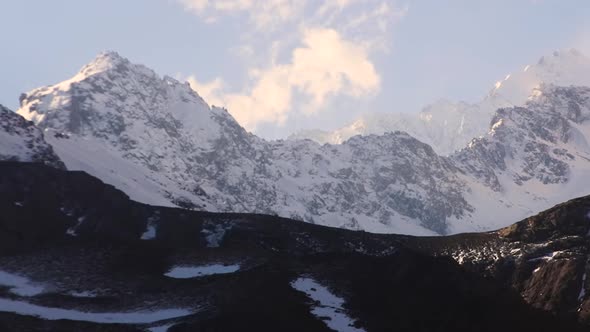 Time Lapse of snowy mountains tops and clouds on a sunny day at Cajon del Maipo, Chile-4K