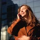 Laughing young woman having phone call outdoors - VideoHive Item for Sale