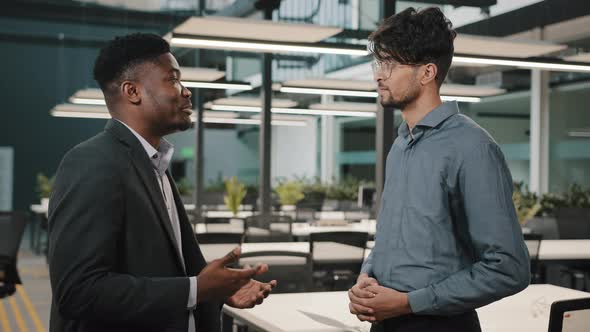 American Arabian Multiethnic Professional Entrepreneurs Shake Male Hands at Office Meeting