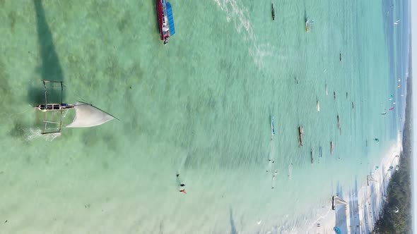 Vertical Video Boats in the Ocean Near the Coast of Zanzibar Tanzania Aerial View