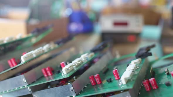 Slider Shot of a Connectors Component and Large Green Microcircuit in Workshop Laboratory