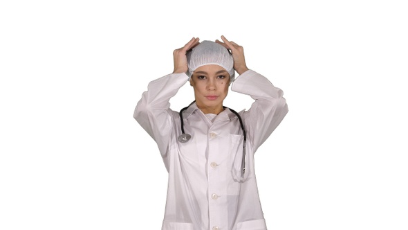 Medical doctor with stethoscope putting medical hat or