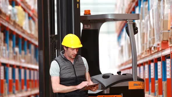 Male warehouse worker using digital tablet