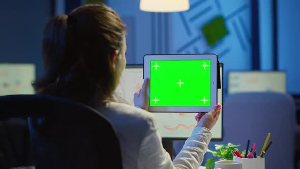 Businesswoman Holding Tablet with Green Screen Monitor