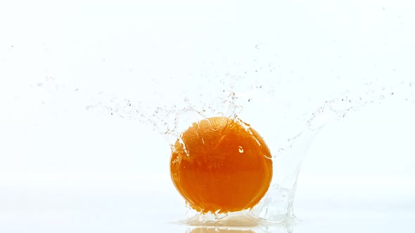 Fresh Orange Dropped Into Water with Splash at 1000 Fps