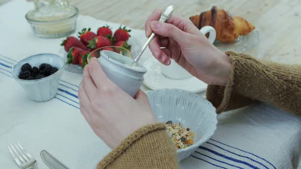 Woman Adding Yoghurt Into Cereal Box