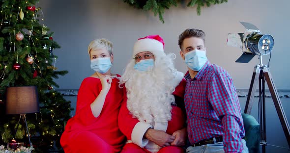 Young Couple Wearing Face Masks Santa Claus Hat Sitting Home