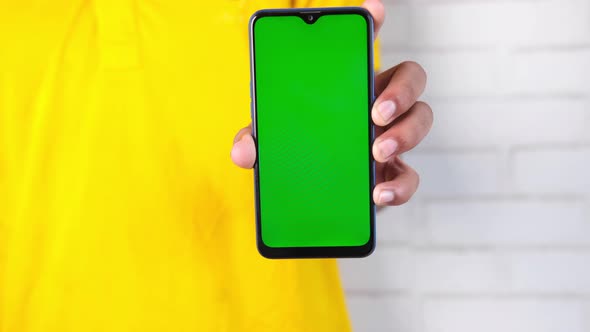 Close Up of Young Man Hand Using Smart Phone with Green Screen