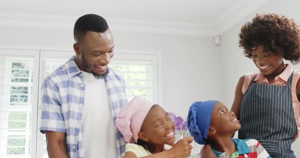 Happy family preparing food in kitchen