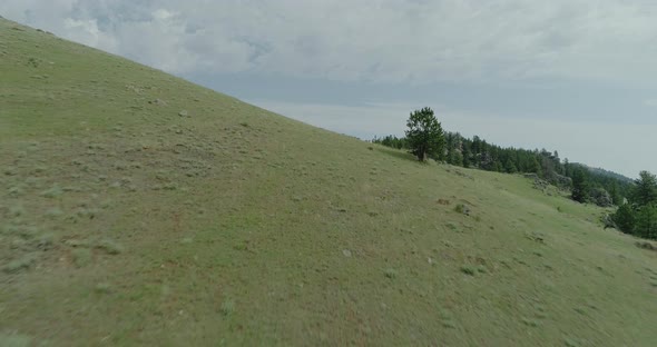 Low sweeping aerial of canyon in the Bighorn Mountains of Wyoming. Imagery includes steep cliffs, de