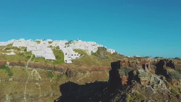 4k Aerial drone footage flying next to Skaros rock Santorini Greece dramatic scenery