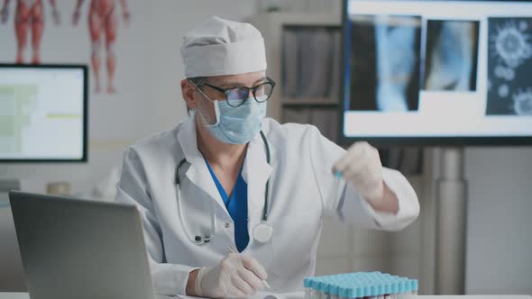 Doctor Making Records of Blood Sample Tests Results alt