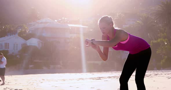 Woman checking time on beach